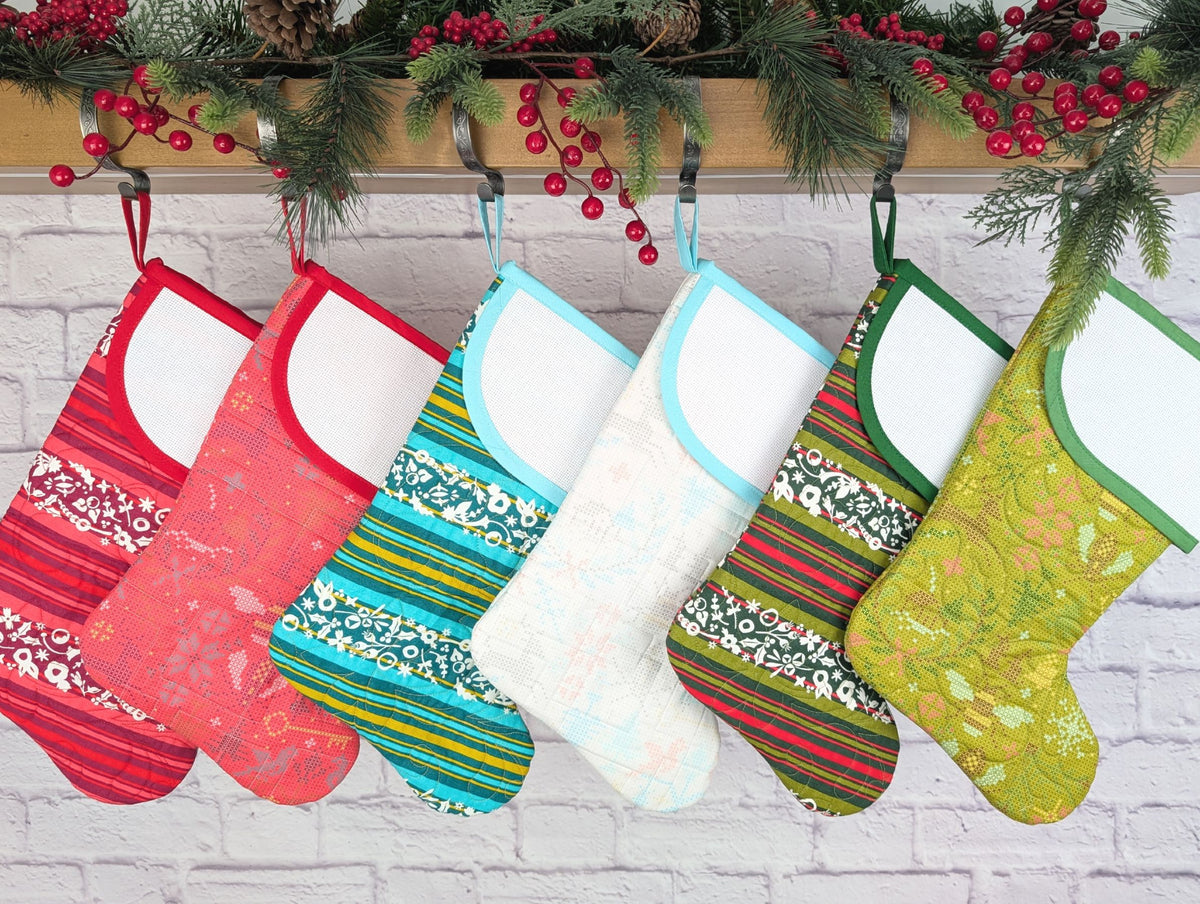 Colorful Christmas stockings hanging on a brick wall with festive decorations.