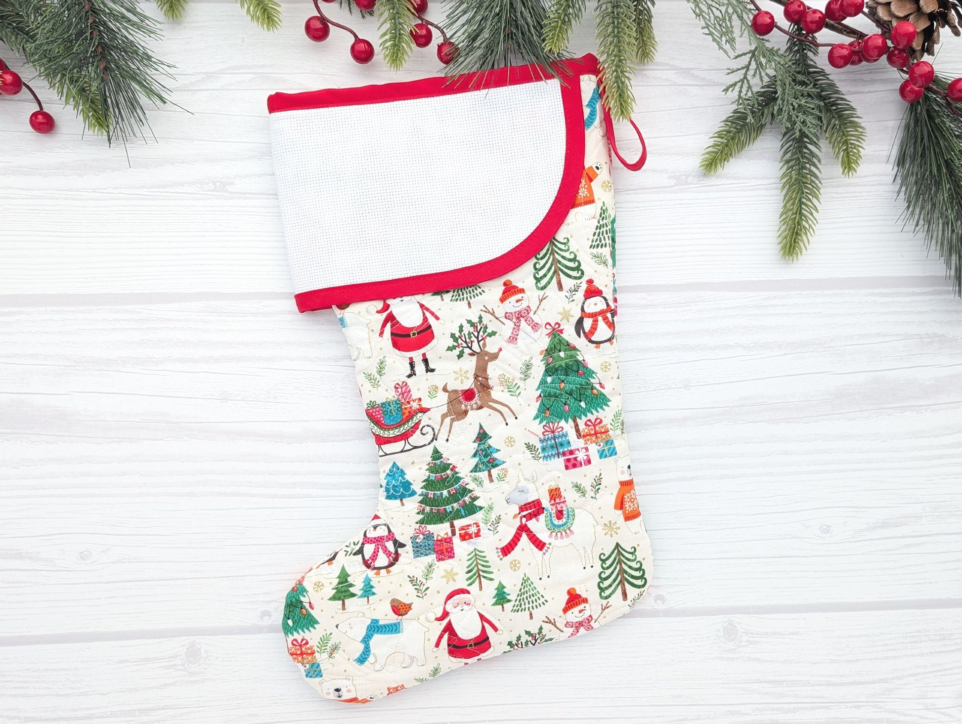 Christmas stocking with festive pattern on a white wooden background