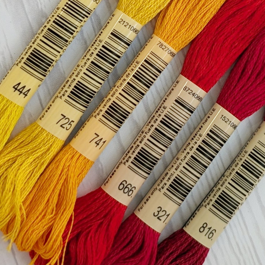 dmc embroidery floss bundle featuring reds, yellows, and oranges