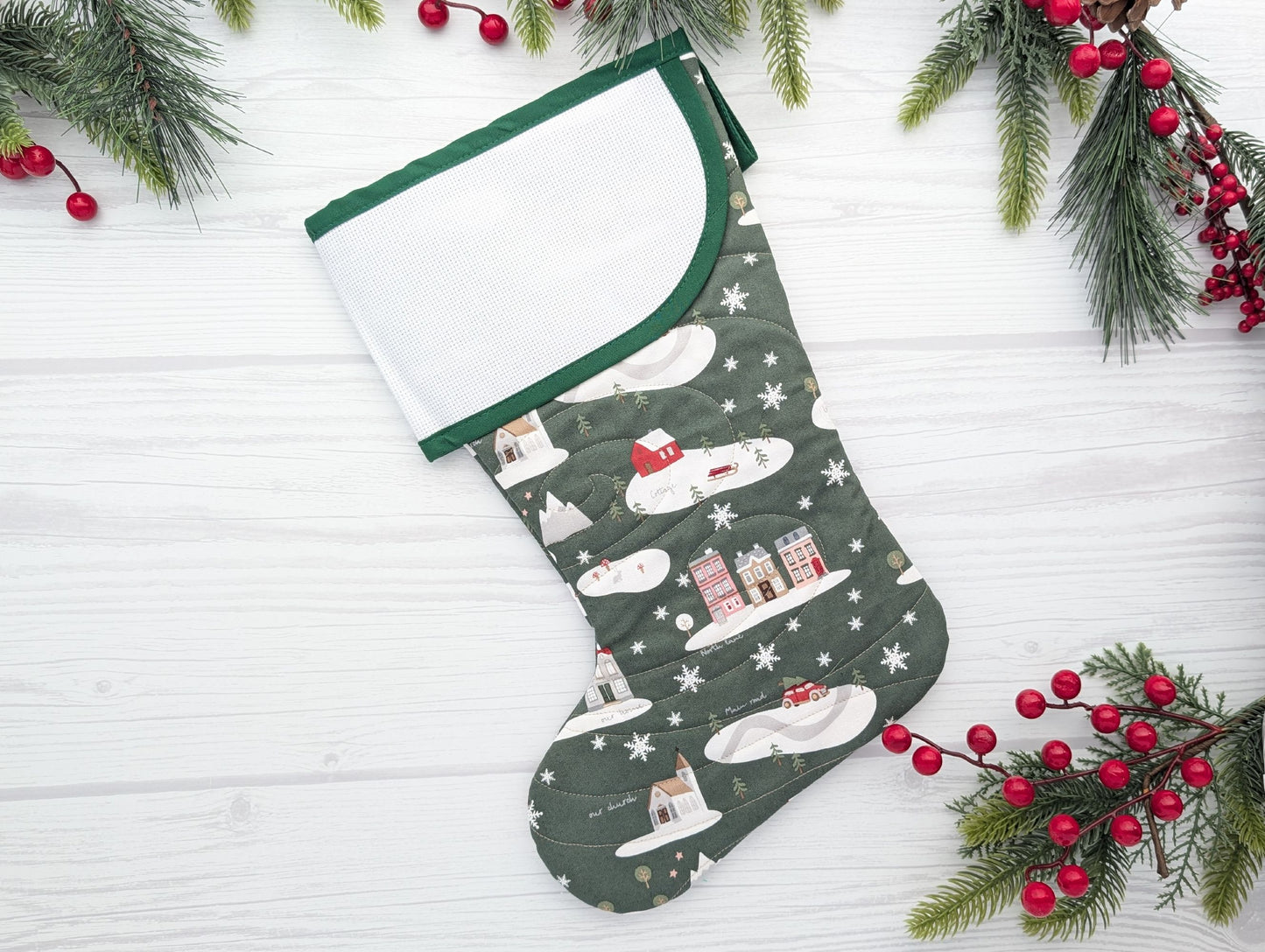 green village quilted Christmas stocking with blank cross stitch cuff