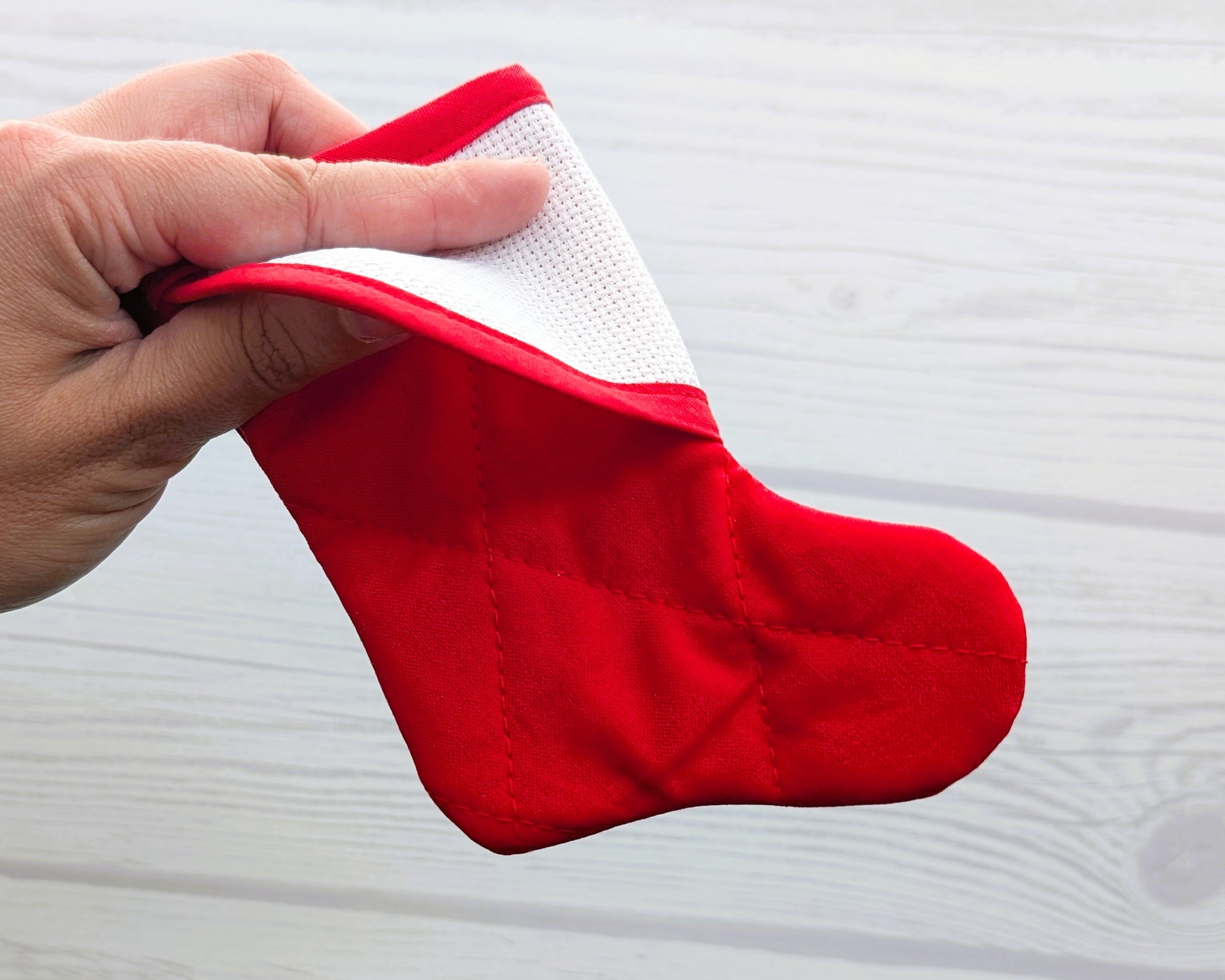 mini christmas stocking with blank cross-stitchable cuff close up in hand