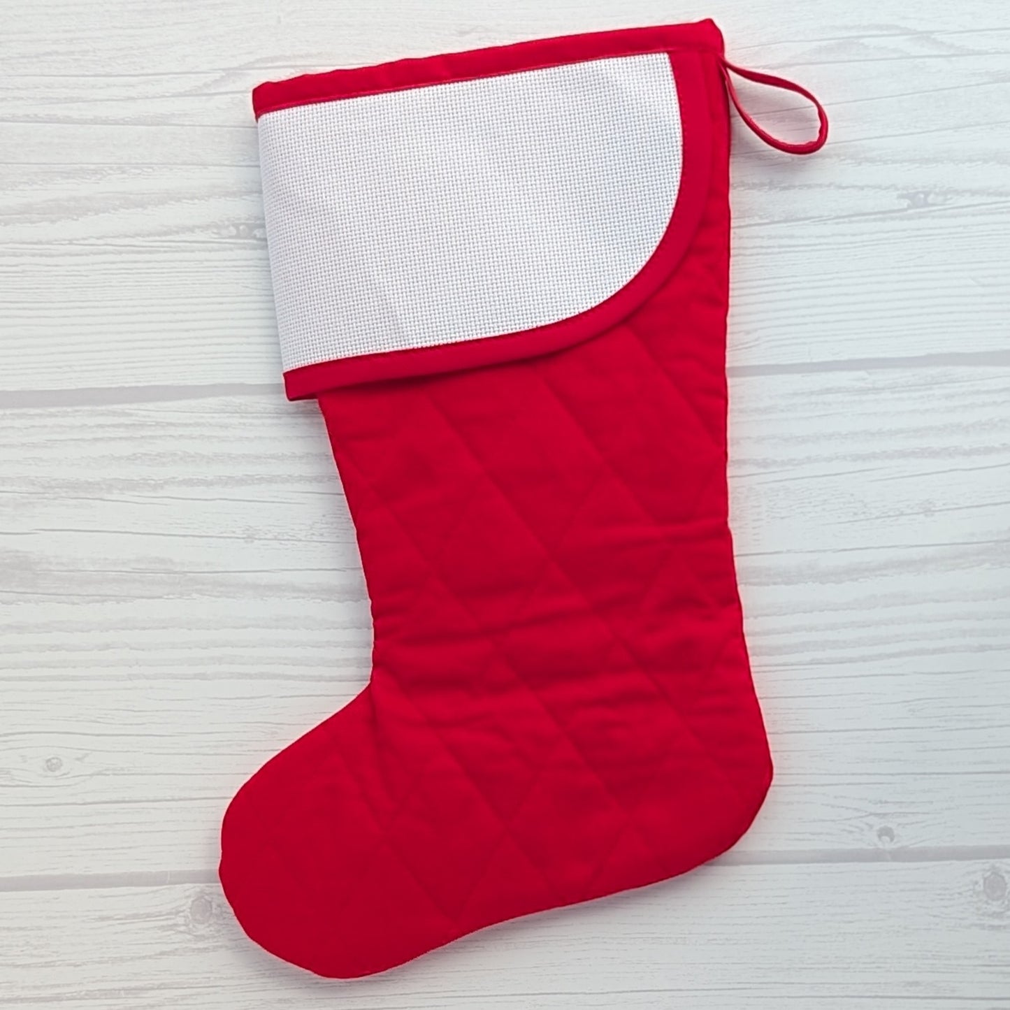 red Christmas stocking with blank cross stitch cuff