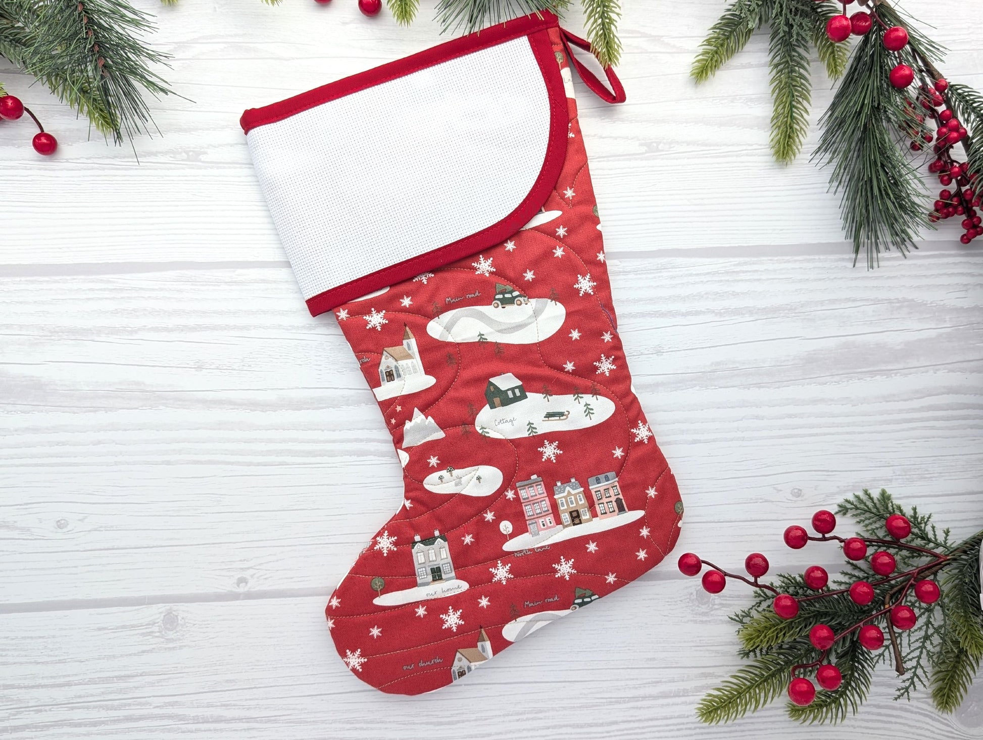 red village quilted Christmas stocking with blank cross stitch cuff
