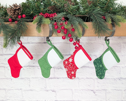 mini christmas stocking with blank cross-stitchable cuff hanging on mantle