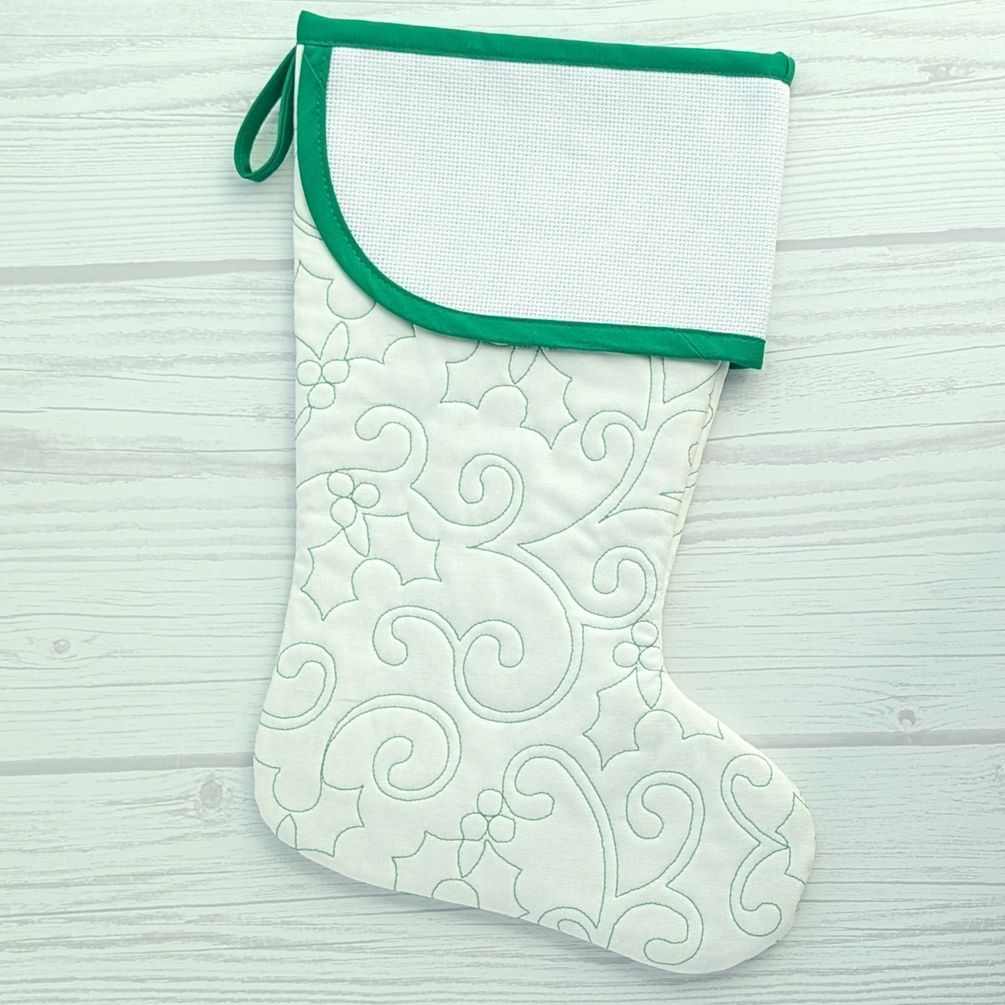 White Christmas stocking with green trim and blank cross stitch cuff