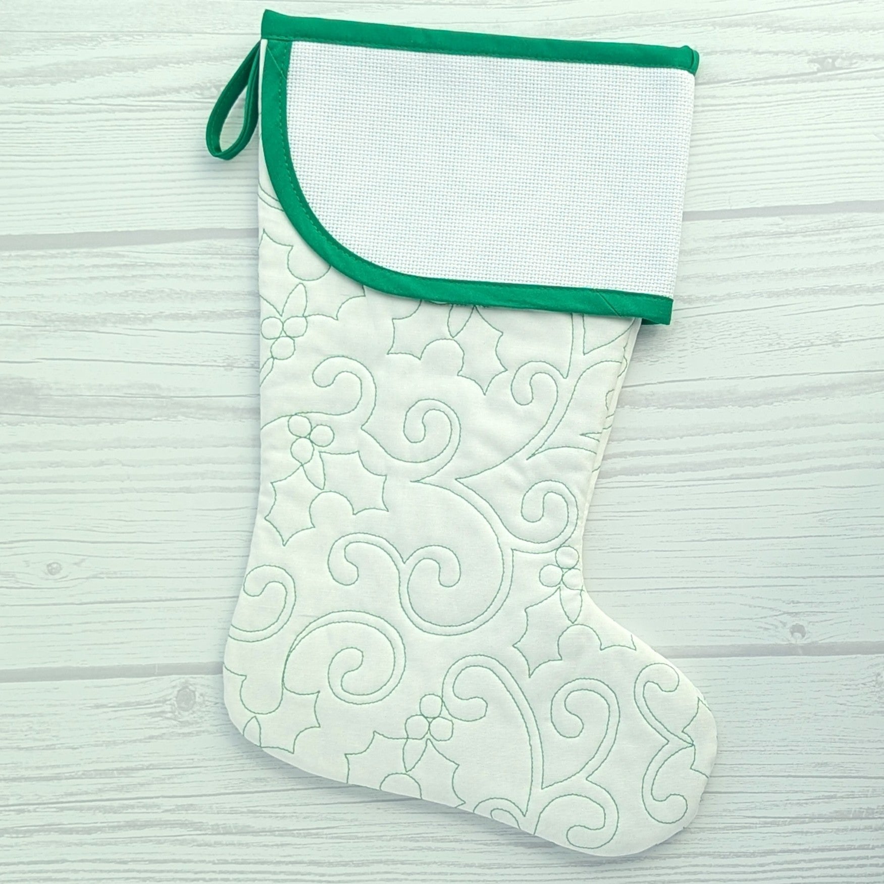 White Christmas stocking with green trim and blank cross stitch cuff