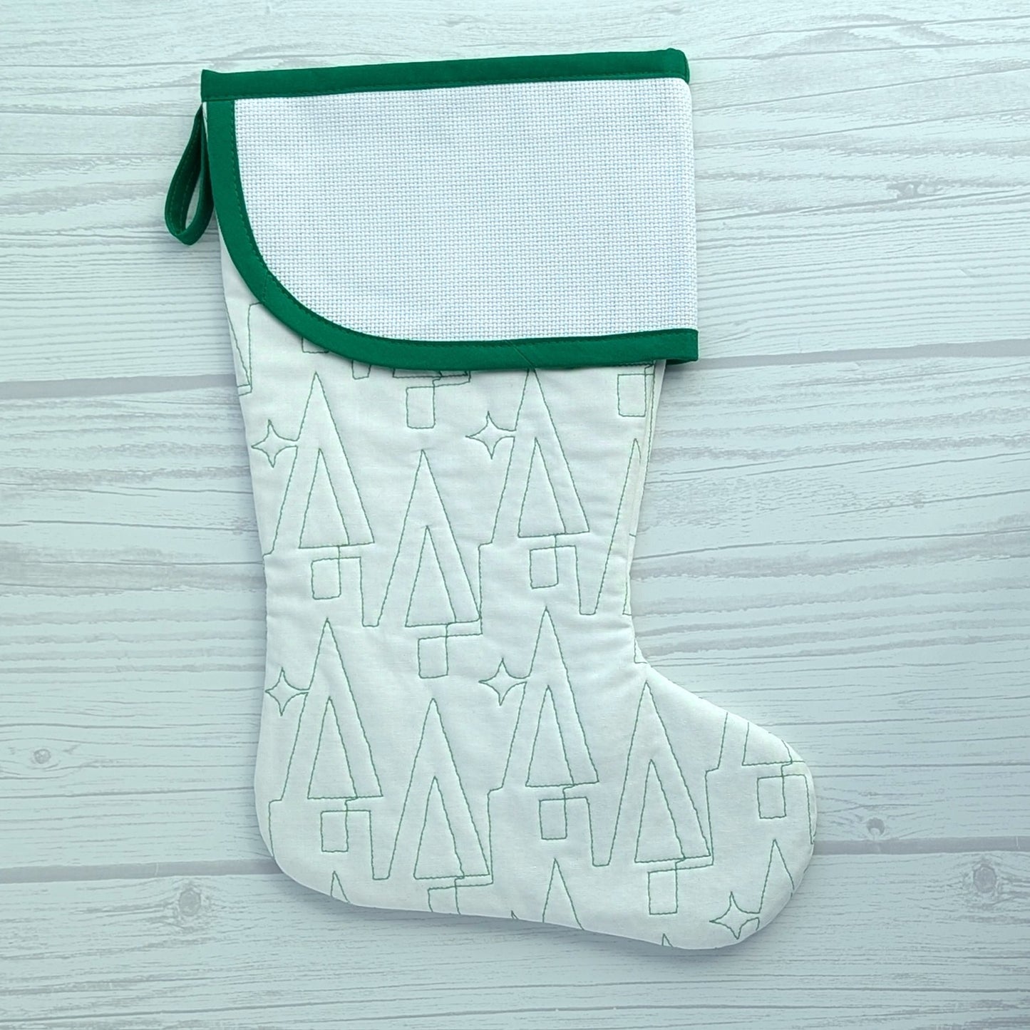 White Christmas stocking with green trim and blank cross stitch cuff