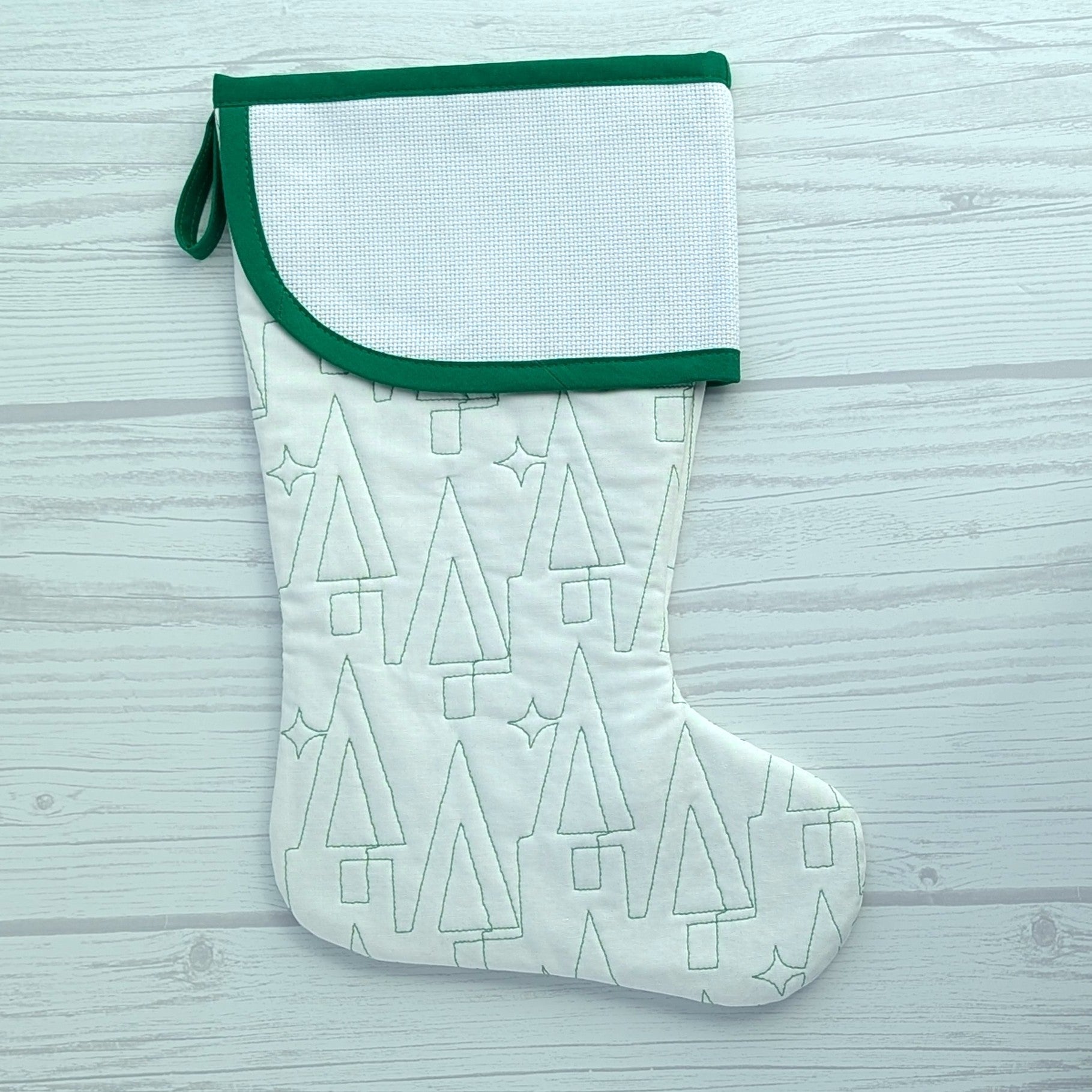 White Christmas stocking with green trim and blank cross stitch cuff